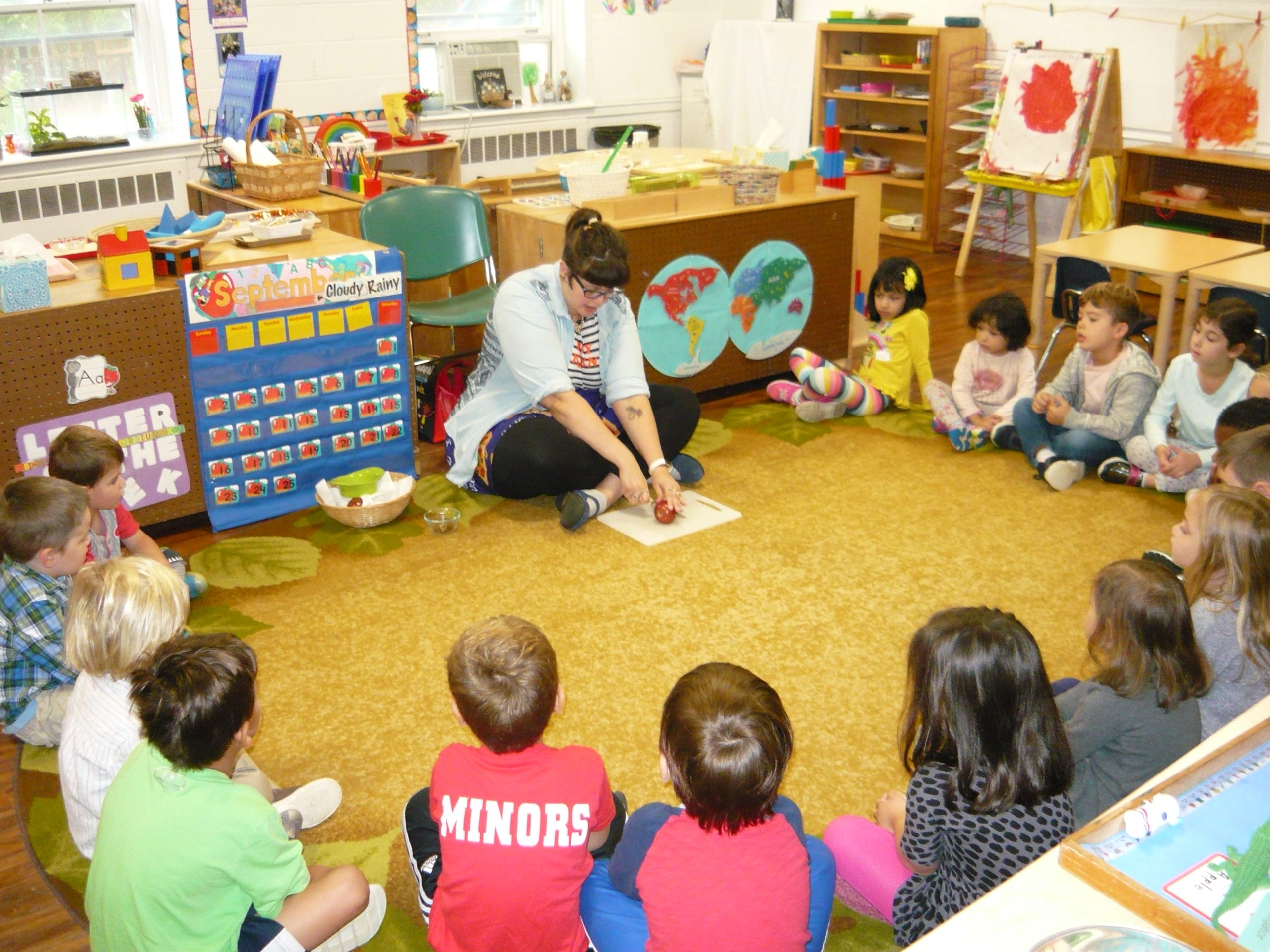 teacher teaching children in classroom